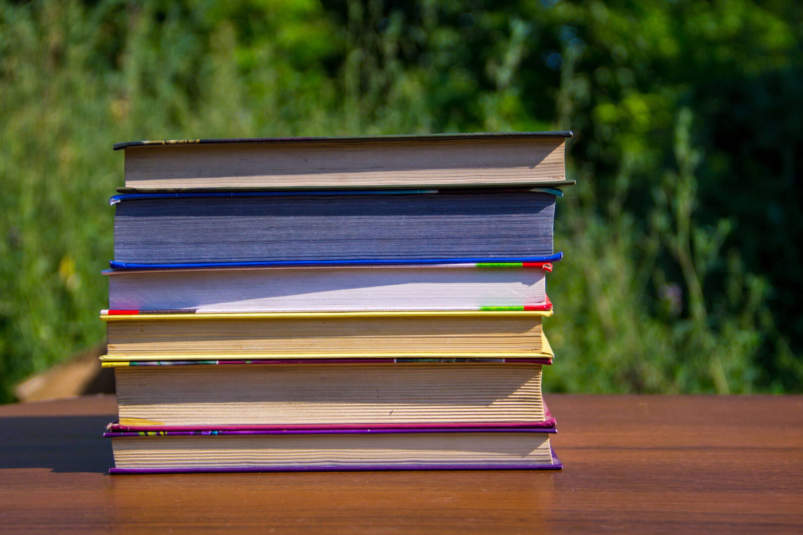 stack-of-the-books-on-wooden-table-outdoor-2025-10-16-16-54-00-utc